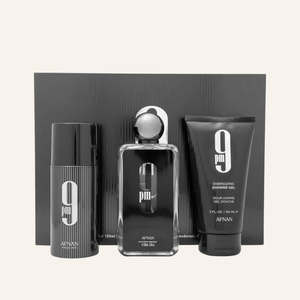 A men's fragrance gift set by AFNAN, featuring a black spray bottle, a cylindrical deodorant or body spray canister, and a shower gel tube, arranged in front of a black rectangular box on a light beige background.