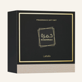 A square black fragrance gift set box with gold foil border and text reading 'FRAGRANCE GIFT SET' and 'Khamrah', plus the brand name 'Latafa' near the bottom. The front panel has Arabic lettering, and the lower section shows a light woodgrain texture.