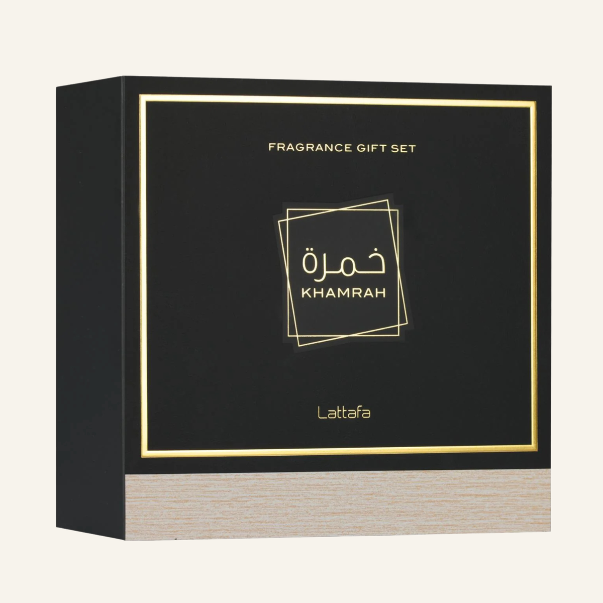 A square black fragrance gift set box with gold foil border and text reading 'FRAGRANCE GIFT SET' and 'Khamrah', plus the brand name 'Latafa' near the bottom. The front panel has Arabic lettering, and the lower section shows a light woodgrain texture.