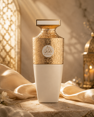 Decorative bottle with gold and white design on a textured surface