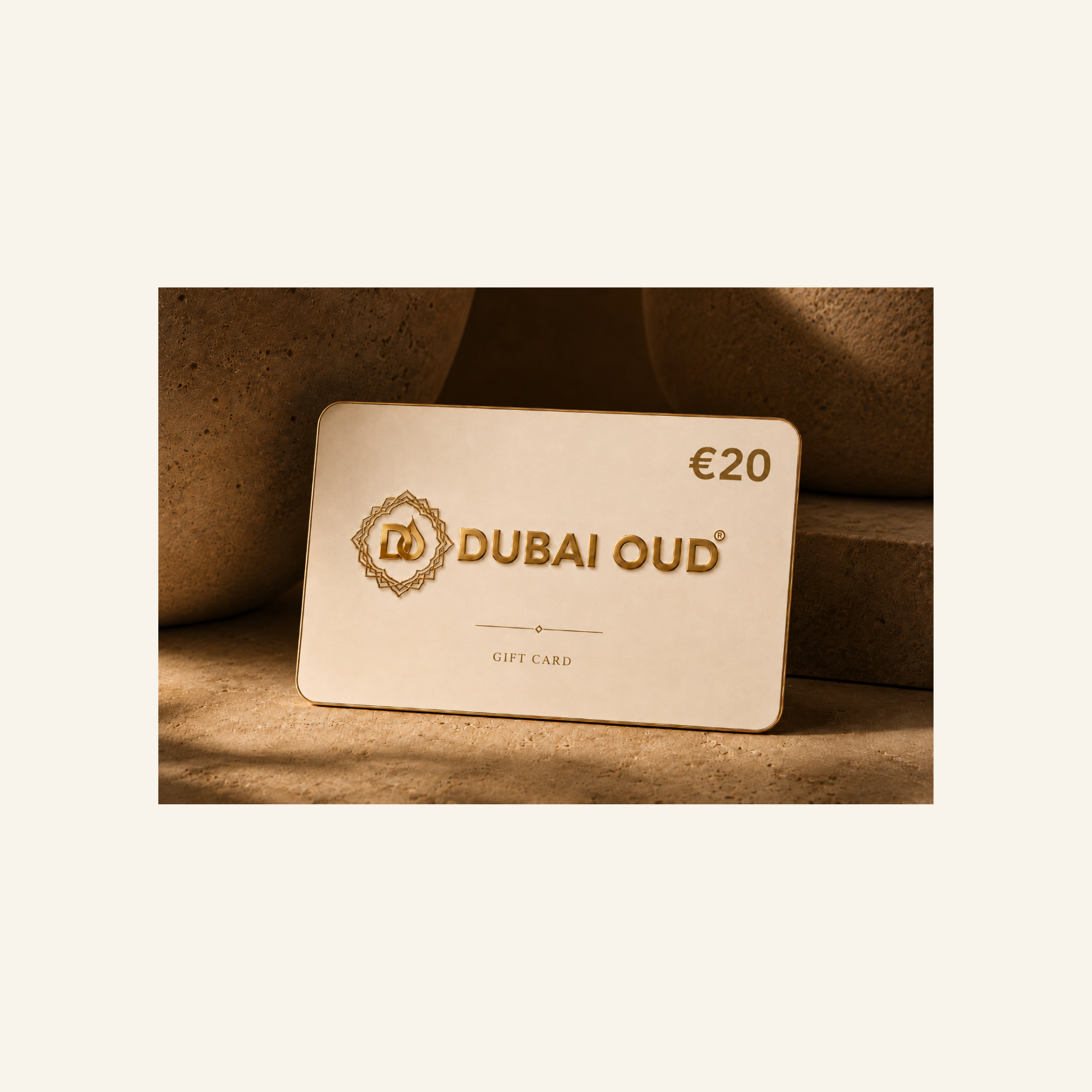 A Dubai Oud €20 gift card with gold foil lettering and logo, displayed on a textured beige stone surface with soft shadows.