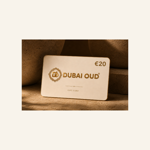 A Dubai Oud €20 gift card with gold foil lettering and logo, displayed on a textured beige stone surface with soft shadows.