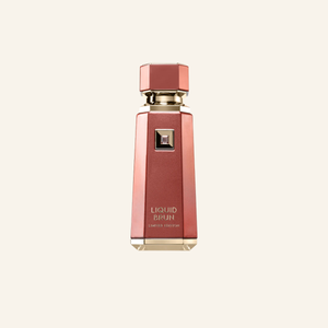 A faceted metallic rose gold perfume bottle with gold lettering that reads 'LIQUID BIRUN' and 'LIMITED EDITION' on a light cream background.