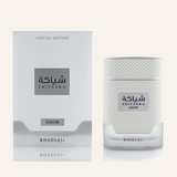 Khadlaj Shiyaaka Snow EDP 100ml bottle, Dubai Oud background #f7f3ec