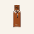 Vulcan Sable perfume bottle by Dior, featuring a warm brown body with a metallic rose gold snake detail and a patterned cap, set against a solid off-white background.